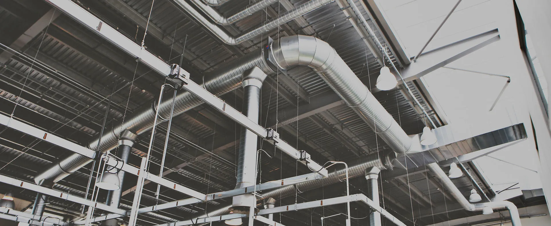 Industrial compressed air piping across a plant ceiling